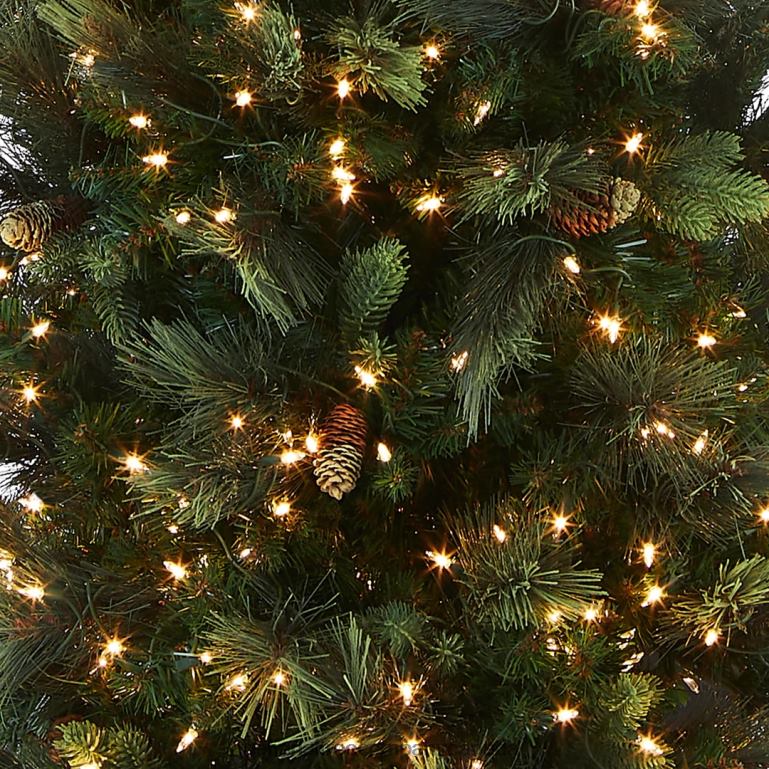 National Tree Company Pre-Lit Artificial Giant Slim Christmas Tree Green Carolina Pine White Lights Flocked with Pine Cones Includes Stand 12 feet 68R0843